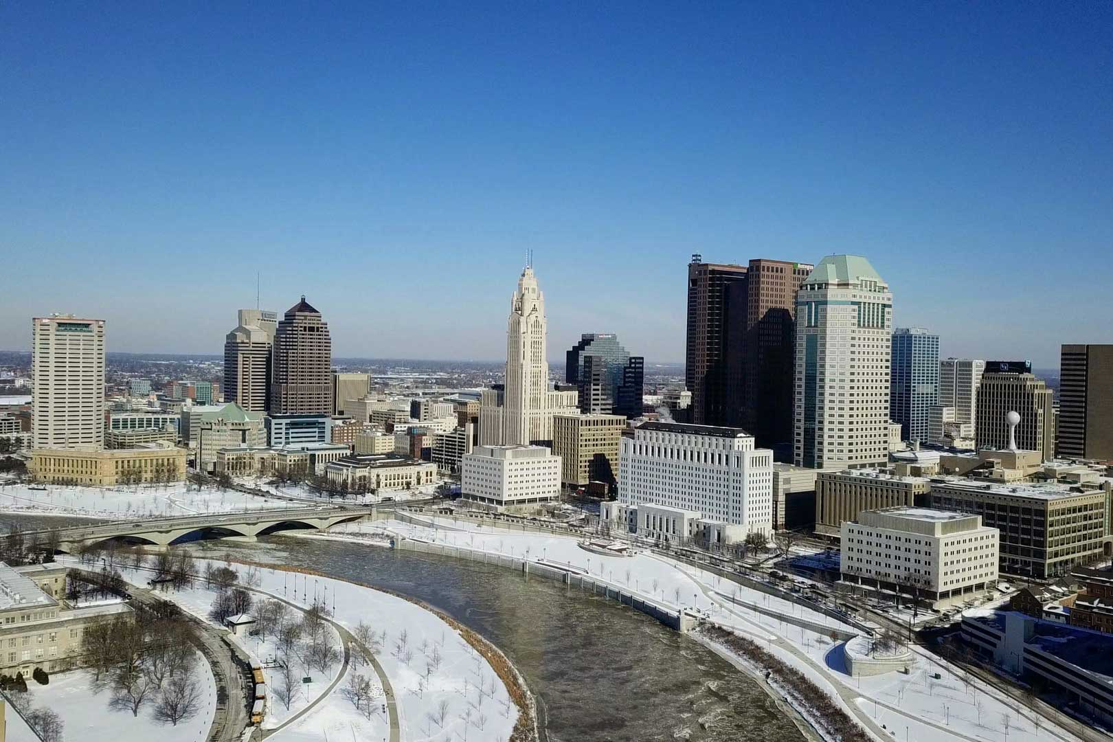 columbus skyline with snow covered riverbank