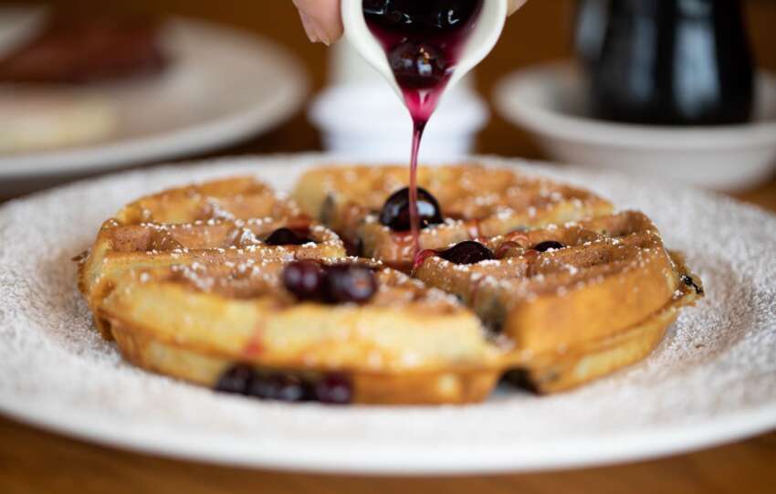 waffle with syrup being drizzled