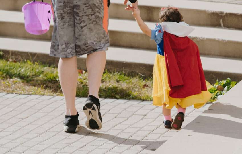 child trick or treating with parent