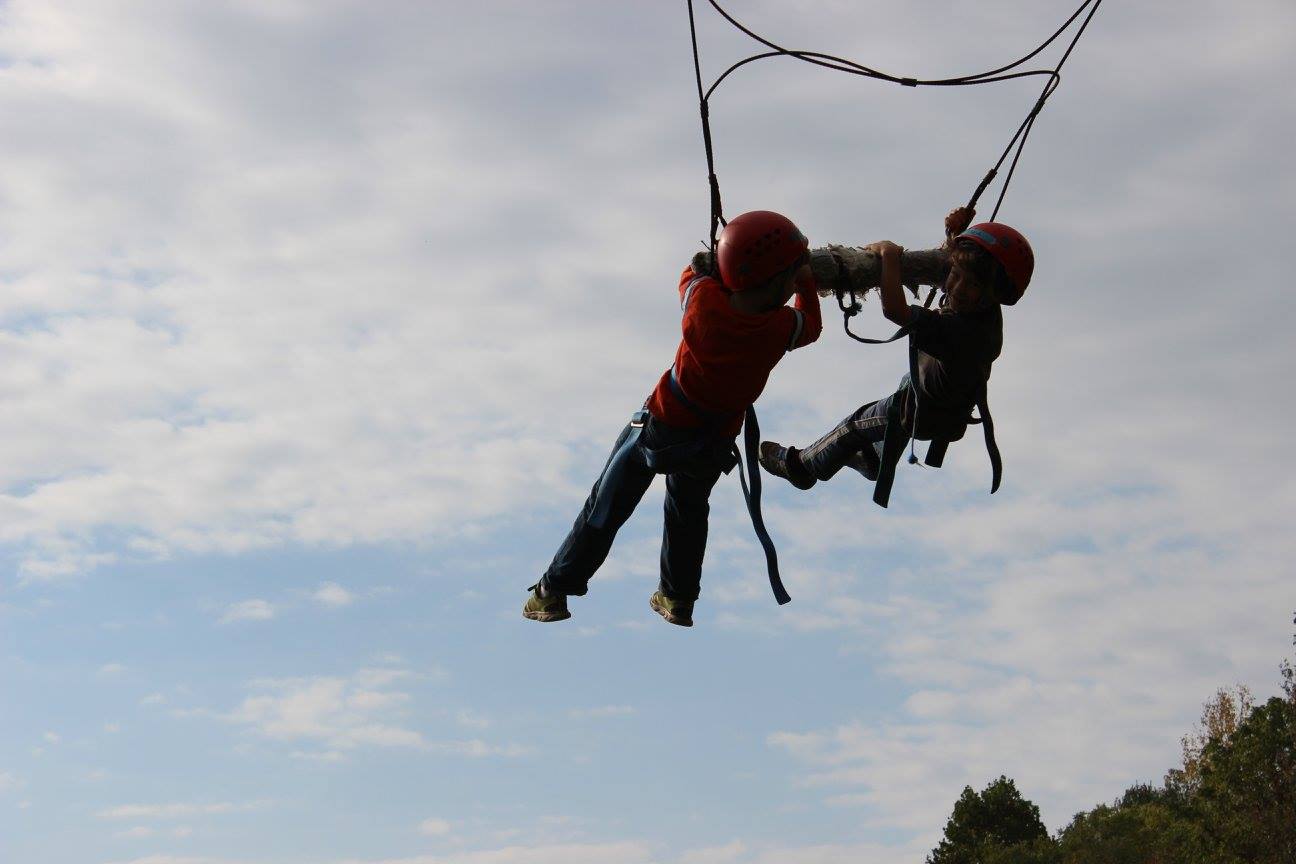 two kids on swing at camp willson
